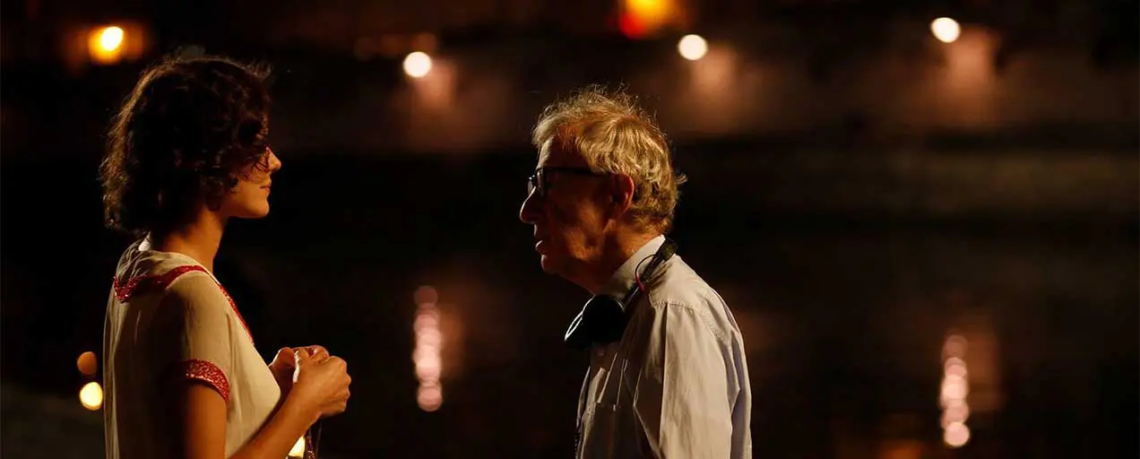 Woody Allen and a woman talking at night.