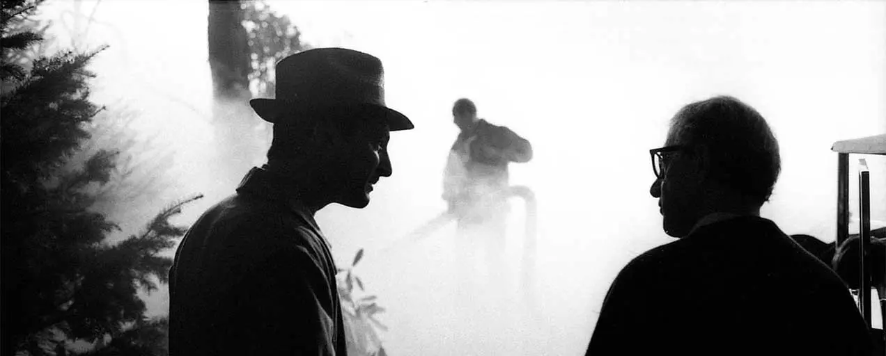 Black and white photo of two men talking.