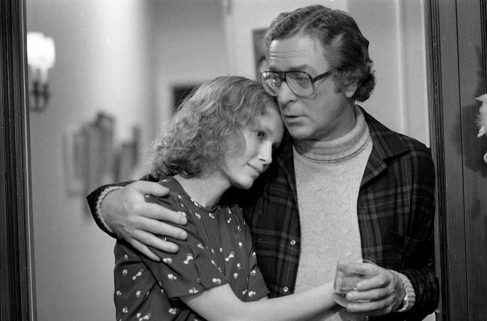 Man comforting woman in a heartfelt embrace.
